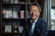 © Bubi Studio - Executive Japanese American CEO in Professional Attire Smiling in Office with Books and Awards Background