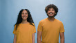 © Yuliia - Studio portrait Indian family Arabian happy smiling couple Hispanic laughing man woman smile laugh carefree cheerful positive looking at camera fun married wife husband models together blue background