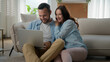 © Yuliia - Happy family couple man Caucasian woman girlfriend boyfriend wife husband shopping online laptop using computer excited win at home internet achievement victory winning celebrating success betting