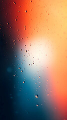 Wall Mural - Raindrops on a glass with a blurred background of orange and blue.