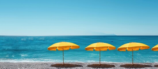 Wall Mural - Yellow sun umbrellas and a blue sky over the sea Concept of summer vacations. with copy space image. Place for adding text or design