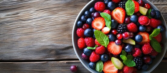 Leinwandbilder - Fresh berry salad on a plate against a wooden background Flat lay top view copyspace