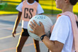 © Austockphoto - detail of child holding netball with unidentified teammate