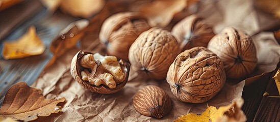 Poster - Textured vintage paper background featuring freshly harvested walnuts. with copy space image. Place for adding text or design