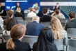 © Anton Gvozdikov - Business seminar featuring audience listening to speakers, discussing industry topics, networking opportunities, and professional development.