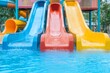 © Boontharika - Bright and colorful water slides at an outdoor amusement park. Perfect for family fun and summer activities.