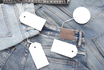 Wall Mural - Assortment of many different fashionable jeans pants with with blank paper tags. Shopping, sale concept