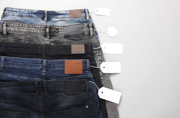 Wall Mural - Assortment of many different fashionable jeans pants with with black paper tags. Shopping, sale concept