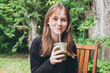 © ADDICTIVE STOCK - Teenage girl enjoying a summer ice matcha drink outdoors