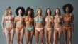 © Ruslan Gilmanshin - A diverse group of women wearing bikinis is happily posing for a picture