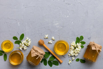 honey jar with acacia flowers and leaves. fresh honey top view flat lay