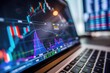 © dashtik - Stock Market Data and Financial Analysis on Laptop Screen in Modern Workspace