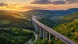 © Faxri - An overhead picture of a motorway bridge that connects towns at dusk, spanning a valley with verdant hills and forests as part of infrastructure development