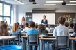 © Larisa - Students in class listening to teacher near whiteboard