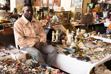 Wall Mural - Ordinary african american guy sells things at a flea market