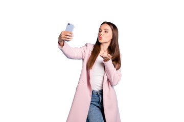 Sticker - Portrait of cute charming lady sending air kisses to her boyfriend taking selfie wearing topcoat denim jeans isolated over blue  color background