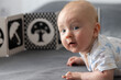 © Vitalina - Portrait of the curious newborn baby with black and white contrast book.