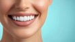 © Pricha.RT - A detailed image of a woman's radiant smile with perfectly aligned white teeth, set against a soft light blue background.