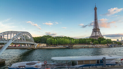 Wall Mural - Eiffel tower with Debilly Footbridge and Jena bridge over Seine evening timelapse, Paris, France