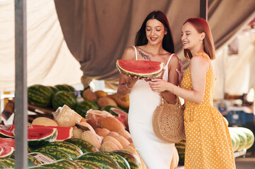 Wall Mural - Fresh watermelon. Two women are together on the marker or bazaar