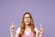 © ViDi Studio - Young successful employee business woman corporate lawyer wears white t-shirt vest glasses point index finger overhead on area isolated on plain pastel purple background. Achievement career concept.