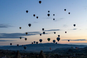 Hot air balloons rise before the sun rises