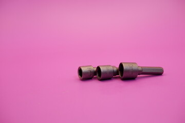 hexagon screwdriver bit sockets measuring 7 mm, 8 mm, and 10 mm isolated on purple background.