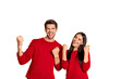 © deagreez - Portrait of cheerful two people raise fists scream yeah celebrate victory wear red pullover isolated over yellow background