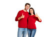 © deagreez - Portrait of lovely spouses show thumb up recommend ads wear red jumper denim jeans isolated over yellow background