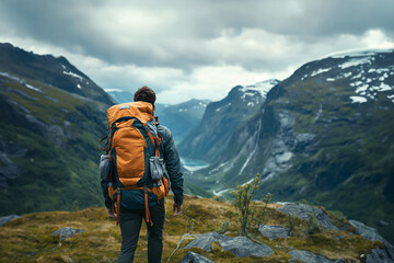 A man tourist backpacker, travel on mountain hills with cloudy day on holiday vacation.