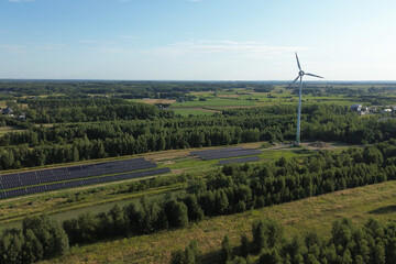 Wind turbine and solar panels in countryside