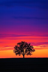 Wall Mural - A high-contrast silhouette of a lone tree standing against a vibrant sunset, with bold colors blending in the sky. 