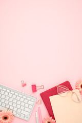 Wall Mural - Home office desk table keyboard, glasses, paper notebooks, supplies, flowers on pink background.