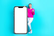 © deagreez - Full length photo of attractive person hold use smart phone big empty space poster isolated on teal color background