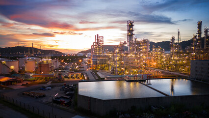 Wall Mural - Oil Refinery plant at sunset. Gas Chemical Equipment Prodiction import export Concept, Crude Oil Refinery Plant Steel Pump Pipe line and Chimney and Cooling tower, Chemical Petrochemical