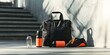 © jambulart - Black gym bag, water bottle, shoe, and a concrete wall.
