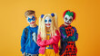 © Diffin - Children Halloween. Children dressed as creepy clowns with vibrant makeup and colorful costumes