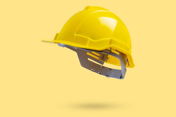 Safety construction helmet on yellow background