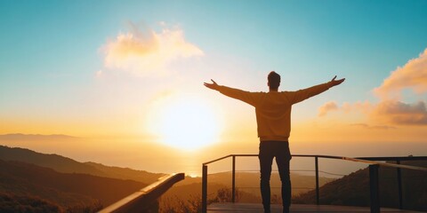 A person stands with arms outstretched, embracing the sunset over a tranquil landscape, symbolizing freedom and hope.