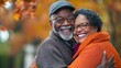 © Pter - Happy senior couple hugging and smiling in an autumn park, with ample space for text. Vibrant colors, studio lighting