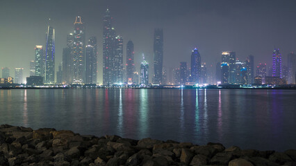 Wall Mural - Dubai Marina skyline as seen from Palm Jumeirah, Dubai, UAE. Timelapse