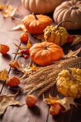 Wall Mural - Thanksgiving home decoration, autumn still life with pumpkins and leaves on wooden background