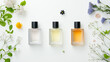 © Wasin Arsasoi - A modern and chic flat lay of designer perfume bottles, with minimalist labels and sleek shapes, arranged on a clean, white surface with hints of fresh flowers and delicate accessories.