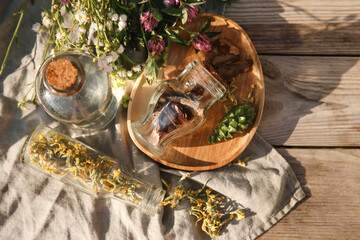 Wall Mural - Tincture and different ingredients on wooden table, top view