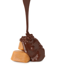 Wall Mural - Pouring delicious melted chocolate onto caramel candies isolated on white