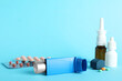 © New Africa - Different asthma medications on light blue background, closeup