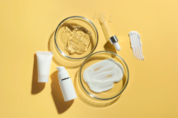 Poster - Petri dishes with cosmetic products and pipette on yellow background, flat lay