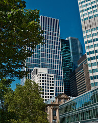 historic building in the middle of a big city jungle with skyscrapers in the background