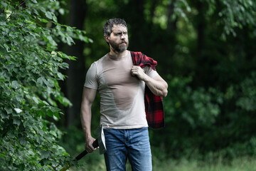 Lumberjack sweating after hardworking. Brutal lumberjack. Brutality and masculinity. Sweating lumberjack man with axe. Lumberjack axe. Man with logging axe. Hardworking brutal man