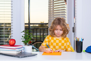 Fototapete - School child studying writing school homework at home. Kid from elementary school. Child pupil doing homework in her room.